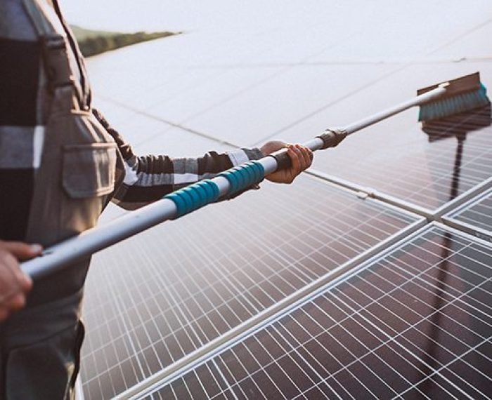 Man worker in the firld by the solar panels